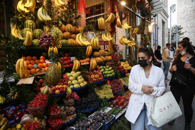 October 14, 2021, Istanbul, Turkey: A woman wearing a mask is seen walking past a greengrocer in Beyoglu, Istanbul. Istanbul Turkey - ZUMAs197 20211014_zaa_s197_447 Copyright: xHakanxAkgunx