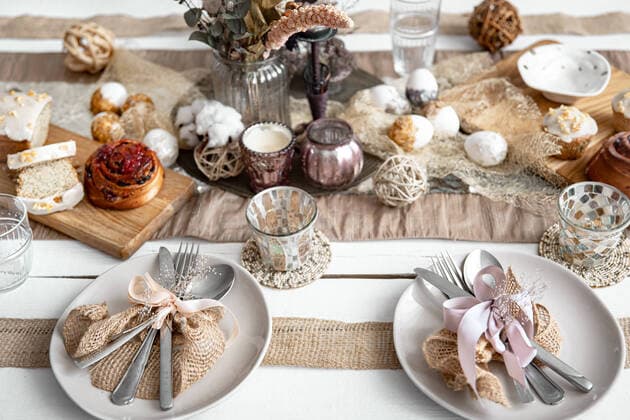 Easter table setting with decor details and homemade cakes top view. A festive table with beautiful dishes, decorative items and pastries. Easter table setting design idea. Copyright: xx 36874396