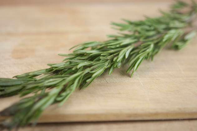 Fresh garden rosemary on wooden table with copy space Copyright: xx 38655408