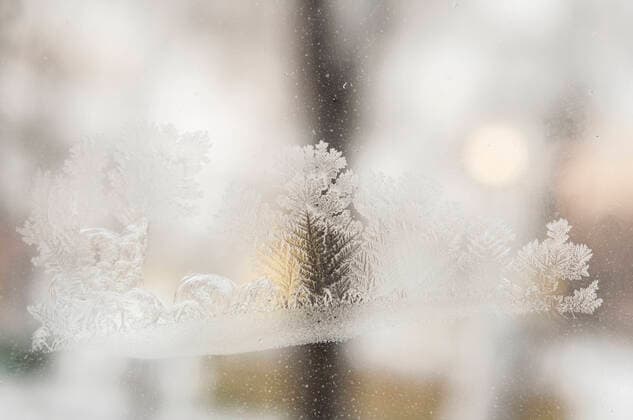 Photographing macro ice on the glass in winter. Beautiful festive frosty pattern with white snowflakes on a blue background on glass Copyright: xx 38661438