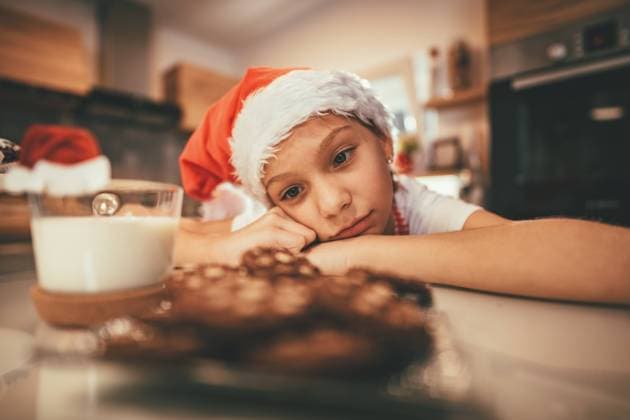 Waiting Santa Clause A little pensive girl looks in a cup of milk and plate with a cookies and waiting Santa Clause. Copyright: xMilanxMarkovicx 39013764