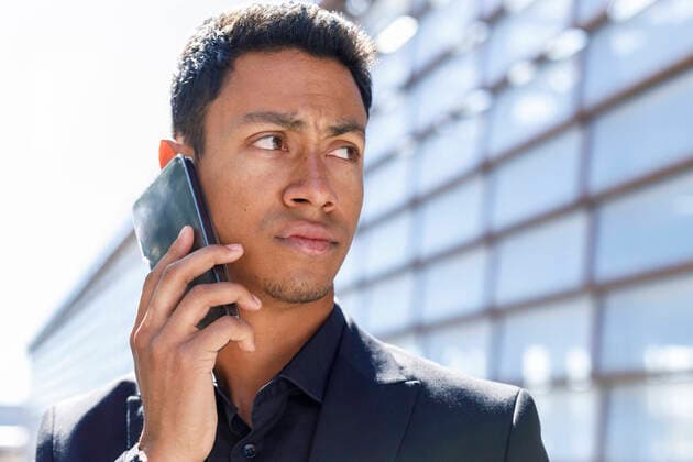 Young male professional talking on mobile phone during sunny day model released Symbolfoto IFRF01092
