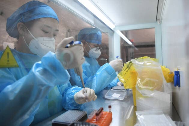 (211024) -- LANZHOU, Oct. 24, 2021 -- Medical workers work at a Falcon air-inflated testing lab for COVID-19 nucleic acid testing in Lanzhou, northwest China s Gansu Province, Oct. 24, 2021. A set of Falcon air-inflated testing lab has been built in Lanzhou for massive nucleic acid tests. The lab is capable of screening up to 800,000 people every day using the ten-in-one mixed testing approach, which greatly improved the testing capabilitiy after the recent resurgence of COVID-19 cases in the city. ) CHINA-GANSU-LANZHOU-COVID-19-TESTING LAB (CN) ChenxBin 