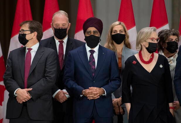 October 26, 2021, Ottawa, ON, CAN: Minister of Natural Resources Jonathan Wilkinson, Minister of International Development and Minister responsible for the Pacific Economic Development Agency of Canada Harjit Sajjan and Minister of Mental Health and Addictions and Associate Minister of Health Carolyn Bennett, who all saw their ministerial positions shuffled, wait for Prime Minister Justin Trudeau to arrive at a news conference after the federal cabinet was sworn in, in Ottawa, on Tuesday, Oct. 26, 2021. Ottawa CAN  - ZUMAc35_ 20211026_zaf_c35_239 Copyright: xJustinxTangx