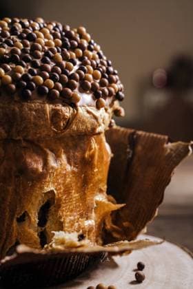 Sweet homemade baked panettone on round wooden stand for celebrating Christmas JayMid_XmasPanettone_15.jpg Copyright: xJayxMidx Model Released