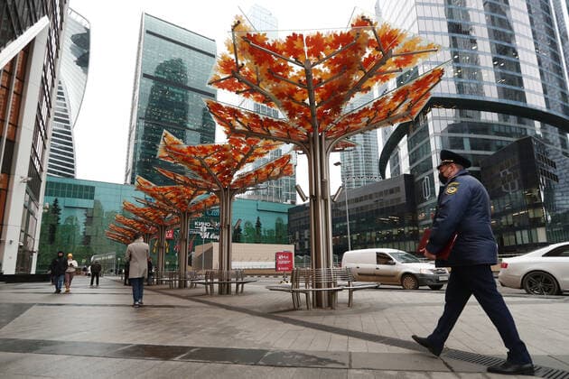 MOSCOW, RUSSIA - OCTOBER 29, 2021: An officer of Moscow s Association of Administrative and Technical Inspections is seen outside the Moscow International Business Center while checking compliance with sanitary and public health safety requirements amid the COVID-19 pandemic. Moscow has announced non-working days from October 28 to November 7 to prevent the spread of the novel coronavirus. Stanislav Krasilnikov TASS  TS116379