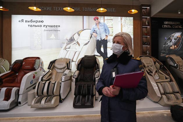 MOSCOW, RUSSIA - OCTOBER 29, 2021: An officer of Moscow s Association of Administrative and Technical Inspections checks compliance with sanitary and public health safety requirements at the Moscow International Business Center amid the COVID-19 pandemic. Moscow has announced non-working days from October 28 to November 7 to prevent the spread of the novel coronavirus. Stanislav Krasilnikov TASS  TS11637A
