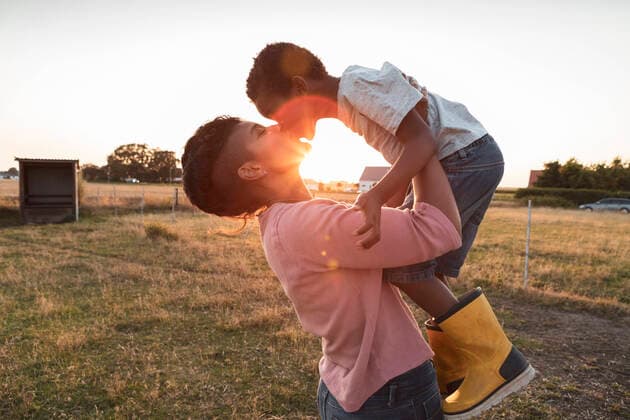 Mother kissing son while carrying him at farm during sunset Sweden, Skane, model released, property released Copyright: xMaskotx , MA89237