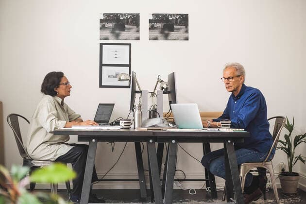 Senior male and female colleagues working on computer in office Sweden, Stockholm, model released, property released Copyright: xMaskotx , MA89351