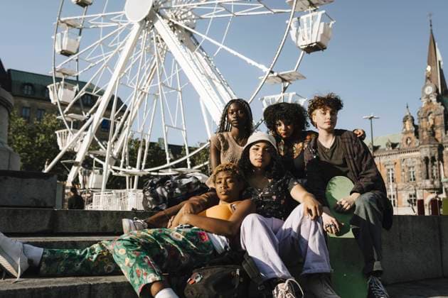 Portrait of confident multiracial friends against Ferris wheel Sweden, Malmo, model released Copyright: xMaskotx , MA89723