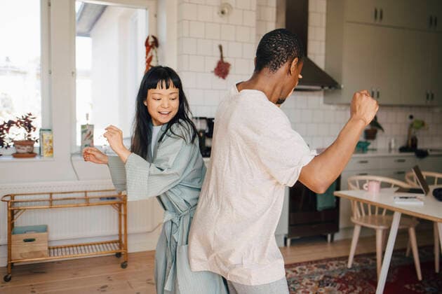 Joyful female and male friend dancing at home Sweden, Stockholm, model released, property released Copyright: xMaskotx , MA90040