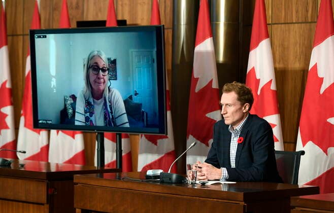 October 29, 2021, Ottawa, ON, CAN: Minister of Crown-Indigenous Relations Marc Miller, right, listens as Minister of Indigenous Services Patty Hajdu, appearing via video conference at left, speaks during a news conference regarding the order from the Canadian Human Rights Tribunal to compensate Indigenous children and their families, in Ottawa, on Friday, Oct. 29, 2021. Ottawa CAN  - ZUMAc35_ 20211029_zaf_c35_147 Copyright: xJustinxTangx