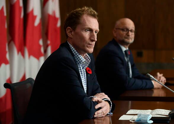 October 29, 2021, Ottawa, ON, CAN: Minister of Crown-Indigenous Relations Marc Miller, left, and Minister of Justice David Lametti listen during a news conference regarding the order from the Canadian Human Rights Tribunal to compensate Indigenous children and their families, in Ottawa, on Friday, Oct. 29, 2021. Ottawa CAN  - ZUMAc35_ 20211029_zaf_c35_154 Copyright: xJustinxTangx