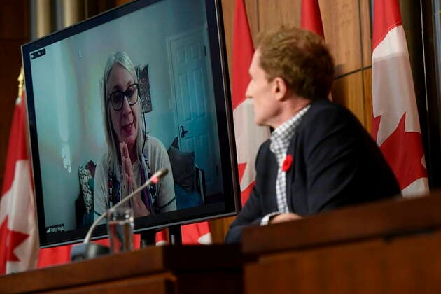 October 29, 2021, Ottawa, ON, CAN: Minister of Crown-Indigenous Relations Marc Miller, right, listens as Minister of Indigenous Services Patty Hajdu, appearing via video conference at left, participates in a news conference regarding the order from the Canadian Human Rights Tribunal to compensate Indigenous children and their families, in Ottawa, on Friday, Oct. 29, 2021. Ottawa CAN  - ZUMAc35_ 20211029_zaf_c35_155 Copyright: xJustinxTangx