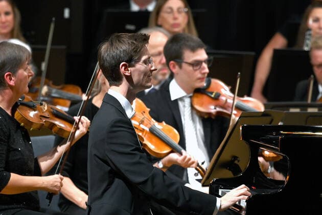 Konzert des Orchesters der Gesellschaft der Musikfreunde Gmunden, im Toskana Kongress, im Rahmen der Salzkammergut Festwochen in Gmunden, am 30.10.21. Das Bild zeigt den Pianisten Florian Feilmair im Spiel, mit ihn umgebenden Geigern 2021 - Konzert des Orchesters der Gesellschaft der Musikfreunde Gmunden, im Toskana Kongress, im Rahmen der Salzkammergut Festwochen in Gmunden, am 30.10.21