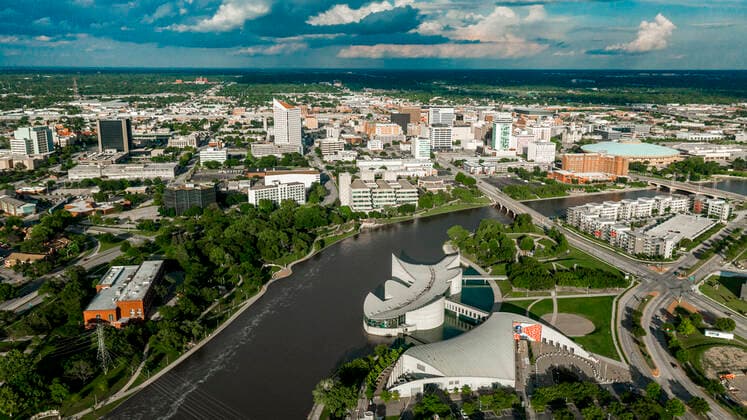 Drone aerial view of downtown Wichita Skyline, Kansas features Exploration Place on Arkansas River. copyrightxjoexsohmx2021xallxrightsxreserved 929_14_voahd-80-652