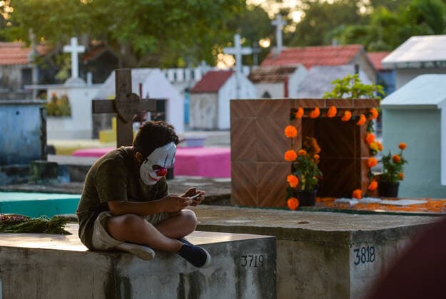 All Saints Day Celebrations In Playa Del Carmen A young boy using a cell phone while sitting on a grave in the municipal cemetery in Playa del Carmen. All Saints Day in Mexico coincides with the first day of the Day of the Dead (Dia de Muertos) celebration. It commemorates children who have died (Dia de los Inocentes) and the second day celebrates all deceased adults. In 2008, the tradition was inscribed in the Representative List of the Intangible Cultural Heritage of Humanity by UNESCO. On Monday, 1 November 2021, in Playa Del Carmen, Quintana Roo, Mexico. Playa Del Carmen Mexico  Copyright: xArturxWidakx widak-allsaint211101_np2WA
