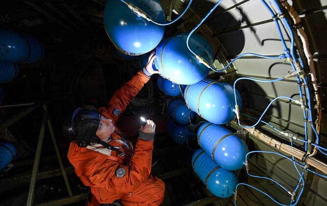 MURMANSK REGION, RUSSIA â€“ NOVEMBER 2, 2021: An Ilyushin Il-38 anti-submarine warfare aircraft crew member of Russia s Northern Fleet naval aviation seen during the fueling of the aircraft with oxygen at the Severomorsk-1 naval air base. Liquefied oxygen is stored and transported in special containers. The Northern Fleet supplies liquefied oxygen to hospitals for COVID-19 patients where there is oxygen shortage. The Northern Fleet has enough oxygen to supply its naval aviation and to help civilian healthcare workers. Lev Fedoseyev TASS  TS116962