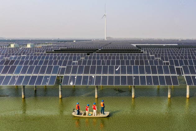(211103) -- YANGZHOU, Nov. 3, 2021 -- Aerial photo taken on Nov. 3, 2021 shows electricity workers patrolling amid a photovoltaic and wind power generation project installed above the fishery waters in Sheyanghu Township of Baoying County of Yangzhou, east China s Jiangsu Province. Baoying County of Yangzhou has been boosting green development by promoting solar and wind energy in recent years. The county s annual power generation from clean energy now reaches 2.1 billion kWh, accounting for 84 percent of the county s annual electricity consumption, equivalent to reducing coal consumption by 840,000 tonnes. ) CHINA-JIANGSU-BAOYING-CLEAN ENERGY (CN) LixBo 