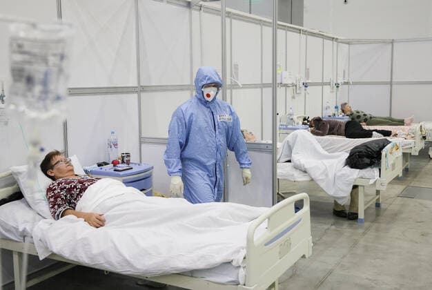 Coronavirus in Russland, EindrÃ¼cke aus provisorischer Covid-19-Einrichtung in Moskau MOSCOW REGION, RUSSIA - NOVEMBER 12, 2021: A medical worker and patients are seen in the red zone of a temporary COVID-19 facility at the Patriot Convention and Exhibition Center of the Russian Armed Forces in the town of Kubinka near Moscow. Moscow Region is listed third after Moscow and St Petersburg with the highest number of COVID-19 cases in Russia; over 1,000 people are hospitalized in the region daily. Gavriil Grigorov TASS  TS117A6D