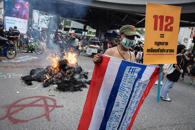 November 14, 2021, Bangkok, Thailand: A protester holds a Thai flag during the demonstration..Pro-democracy protesters gathered at Pathumwan Intersection for a Fighting Against the Absolute Monarchy campaign. This campaign came after a verdict of the Constitutional Court, Judged that three reformation of the monarchy speeches on 10 August 2020 is annihilate the constitutional monarchy. The protesters demand for monarchy reformation and abolition of a criminal law section 112 Bangkok Thailand - ZUMAs197 20211114_zaa_s197_068 Copyright: xVaruthxPongsapipattx