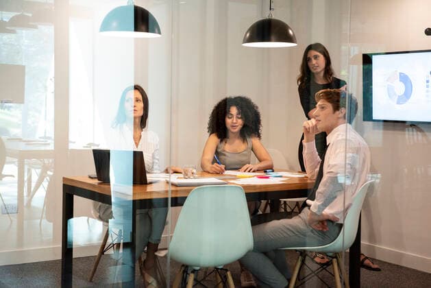 Business people working together in board room Copyright: EricxAudras B52613645