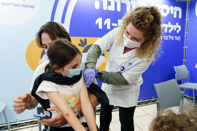 (211123) -- RAMAT HASHARON, Nov. 23, 2021 -- A child receives COVID-19 vaccine at a vaccination site in Ramat Hasharon, Israel, Nov. 22, 2021. Israel on Monday launched a COVID-19 vaccination campaign for children aged 5 to 11, Israel s health maintenance organizations (HMOs) said. ( via Xinhua) ISRAEL-RAMAT HASHARON-COVID-19-VACCINATION-CHILDREN JINI 