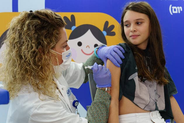 (211123) -- RAMAT HASHARON, Nov. 23, 2021 -- A child receives COVID-19 vaccine at a vaccination site in Ramat Hasharon, Israel, Nov. 22, 2021. Israel on Monday launched a COVID-19 vaccination campaign for children aged 5 to 11, Israel s health maintenance organizations (HMOs) said. ( via Xinhua) ISRAEL-RAMAT HASHARON-COVID-19-VACCINATION-CHILDREN JINI 