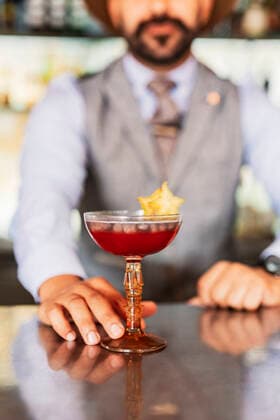 Male bartender serving cocktail at bar counter model released property released, DLTSF02323
