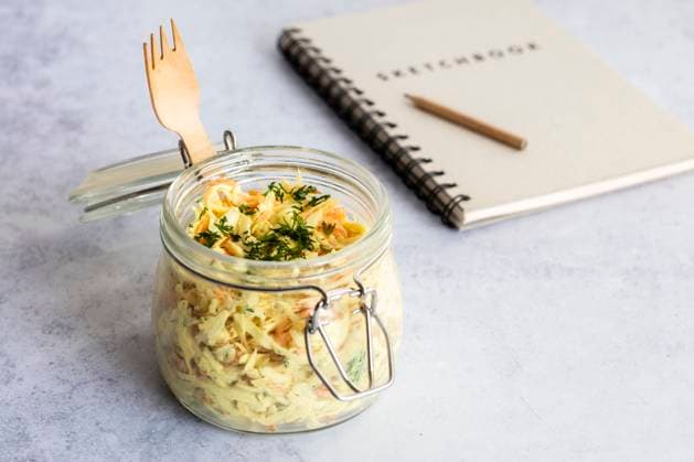 Jar of grated vegetable salad with note pad in background, EVGF03929