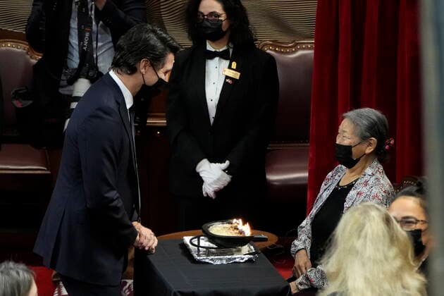 November 23, 2021, Ottawa, ON, Canada: Prime Minister Justin Trudeau speaks with Elder Sally Webster before Gov. Gen. Mary Simon delivers the Throne Speech in the Senate in Ottawa on Tuesday, Nov. 23, 2021. Webster will be tending to the qulliq, a traditional Inuit lamp made of soapstone, throughout the duration of the ceremony. Ottawa Canada  - ZUMAc35_ 20211123_zaf_c35_078 Copyright: xAdrianxWyldx