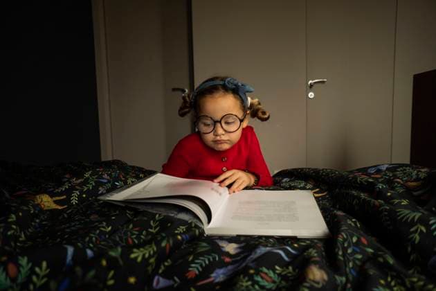 Cute girl reading book in bedroom model released property released, SSGF00215