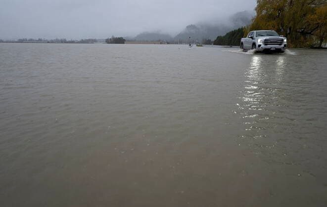 November 25, 2021, ABBOTSFORD, BC, CANADA: A truck drives down a flooded road in Abbotsford, B.C., Thursday, November 25, 2021. ABBOTSFORD CANADA  - ZUMAc35_ 20211125_zaf_c35_120 Copyright: xJonathanxHaywardx