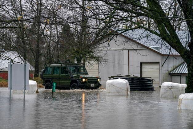 November 25, 2021, ABBOTSFORD, BC, CANADA: Members of the Canadian Forces drive along a flooded road as they patrol Abbotsford, B.C., Thursday, November 25, 2021. ABBOTSFORD CANADA  - ZUMAc35_ 20211125_zaf_c35_123 Copyright: xJonathanxHaywardx
