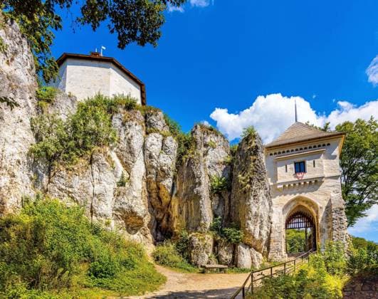 Ojcow, Poland - August 24, 2020: Gate tower and limestone rocky defense walls of medieval royal Ojcow Castle on Cracow-Czestochowa upland in Lesser Poland  BEW1DDB0A8A