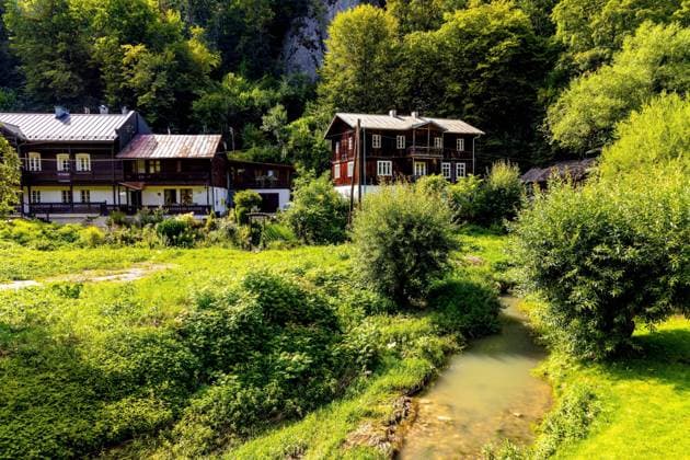 Ojcow, Poland - August 24, 2020: Panoramic view of Pradnik creek valley with traditional wooden households in limestone hills landscape of Cracow-Czestochowa upland in Lesser Poland  BEW1DDC3F38