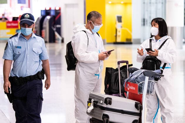 NSW COVID19 OMICRON STRAIN, People wearing PPE arriving at Sydney International Airport in Sydney, Monday, November 29, 2021. The Omicron COVID-19 variant has arrived in Australia after testing confirmed two overseas travellers who arrived in Sydney were infected with the new strain. ( NO ARCHIVING, EDITORIAL USE ONLY, NO USE IN BOOKS WITHOUT CONSENT SYDNEY NSW AUSTRALIA  Copyright: xJAMESxGOURLEYx 20211129001601269091