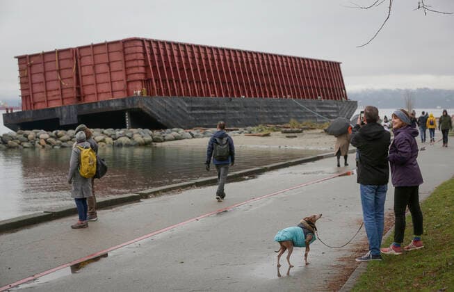 (211129) -- VANCOUVER, Nov. 29, 2021 -- People visit the barge washed up at Sunset Beach in Vancouver, Canada, Nov. 28, 2021. The barge was washed up on Sunset Beach two weeks ago due to the windstorm. (Photo by Xinhua) CANADA-VANCOUVER-BARGE-BEACH LiangxSen 