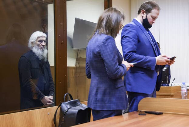 MOSCOW, RUSSIA - NOVEMBER 30, 2021: Unordained schema hegumen Sergius (Nikolai Romanov), left, charged with unsanctioned actions encouraging people to kill themselves and violating the right for freedom of religion over his calling on the faithful to oppose COVID-19 restrictions, attends a sententing hearing at Moscowâ€™s Izmailovsky District Court. The court found Romanov guilty on the three charges and sentenced him to 3 and a half years in prison colony. Romanov was arrested at the Sredneuralsk Convent and sent to Moscow on 29 December 2020; he was excommunicated in May 2020 for violating a ban on preaching after calling on people to go to church despite the lockdown, describing the coronavirus situation as a fake pandemic . More recently  TS11A15B