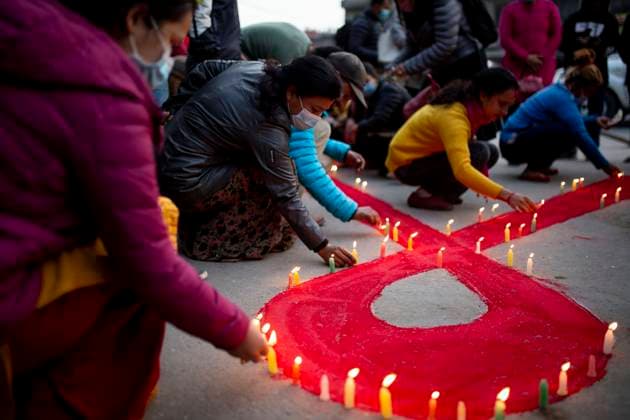(211130) -- KATHMANDU, Nov. 30, 2021 -- Volunteers light candles during an AIDS awareness campaign on the eve of World AIDS Day in Kathmandu, Nepal, Nov. 30, 2021. (Photo by Xinhua) NEPAL-KATHMANDU-WORLD AIDS DAY SulavxShrestha 