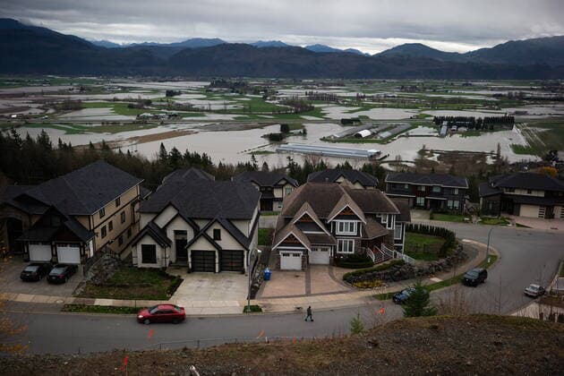 December 1, 2021, ABBOTSFORD, BC, CANADA: A person walks a dog in a residential neighbourhood on a mountain overlooking flooded farmland in Abbotsford, B.C., on Wednesday, December 1, 2021. ABBOTSFORD CANADA  - ZUMAc35_ 20211201_zaf_c35_109 Copyright: xDarrylxDyckx