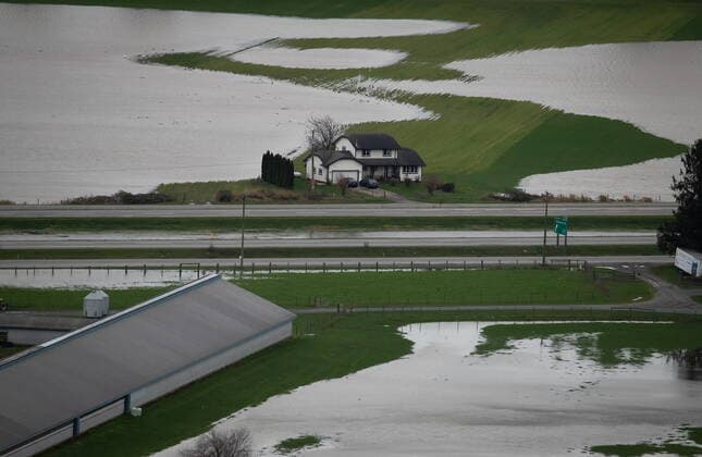 December 1, 2021, ABBOTSFORD, BC, CANADA: A house sits on high ground among flooded farmland in Abbotsford, B.C., on Wednesday, December 1, 2021. ABBOTSFORD CANADA  - ZUMAc35_ 20211201_zaf_c35_111 Copyright: xDarrylxDyckx