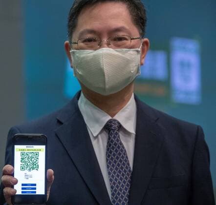 HONG KONG, CHINA - DECEMBER 02: Hong Kong Innovation and Technology Secretary Alfred Sit Wing-hang holds a smartphone displaying a new COVID-19 tracking health code app system at a news conference on December 2, 2021 in Hong Kong, China.  Copyright: xVCGx CFP111360090938