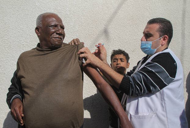 (211202) -- GAZA, Dec. 2, 2021 -- A Palestinian man receives a dose of the COVID-19 vaccine during a vaccination campaign in Gaza City, on Dec. 2, 2021. (Photo by Xinhua) MIDEAST-GAZA CITY-COVID-19-VACCINATION RizekxAbdeljawad 