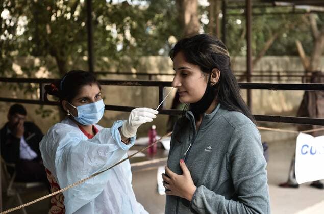 GURUGRAM, INDIA - DECEMBER 5: A health worker colelcts a swab sample for Covid-19 test, at UPHC, on December 5, 2021 in Gurugram, India. (Photo by Vipin Kumar Hindustan Times) Daily Life Amid Covid-19 pandemic In India