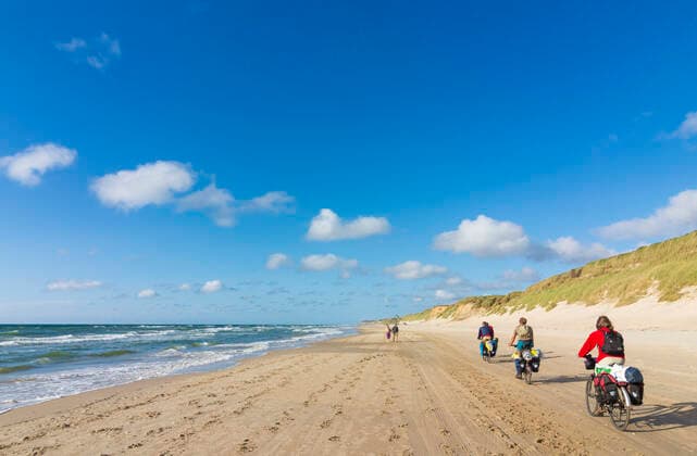 cyclists on beach, sea Hjoerring Jylland, Jutland Denmark Loekken