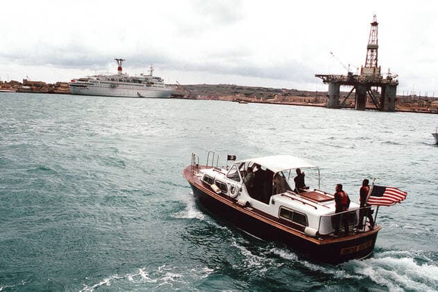 1989 -A 33-foot personnel boat carries President George Bush across the bay toward the Soviet passenger liner MAXSIM GORKIY for a meeting with Soviet Chairman Mikhail Gorbachev. The two leaders had intended to hold their summit talks aboard warships from their respective nations, but poor weather forced the meeting site to be shifted to the Soviet passenger liner MAXSIM GORKIY, which is tied up to a pier ashore. . . 1062_05_L_-8538-