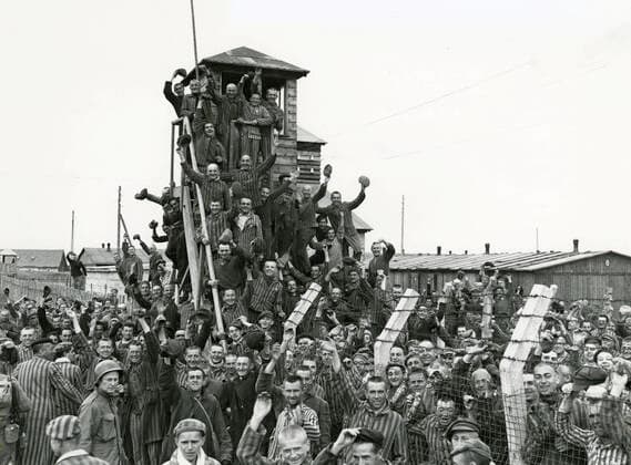 Newly liberated prisoners of the Allach concentration camp celebrate their liberation near Dachau, Germany, April 30, 1945. American Soldiers of the U.S. 7th Army, including members of the 42nd Infantry and 45th Infantry and 20th Armored Divisions participated in the subcamp™s liberation. The main concentration camp at Dachau had more than 120 subcamps in the area . . 1062_33_L_-10384-