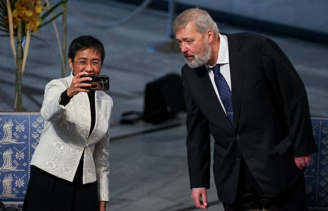 OSLO, NORWAY â€“ DECEMBER 10, 2021: Filipino-American journalist, co-founder and CEO of Rappler Maria Ressa (L) and Russian journalist, Novaya Gazeta editor-in-chief Dmitry Muratov pose for a selfie before the start of the 2021 Nobel Peace Prize award ceremony at Oslo City Hall. The Norwegian Nobel Committee has decided to award the Nobel Peace Prize for 2021 to Maria Ressa and Dmitry Muratov in recognition of their efforts to safeguard freedom of expression, which is a precondition for democracy and lasting peace . Sergei Bobylev TASS  TS11B5A2