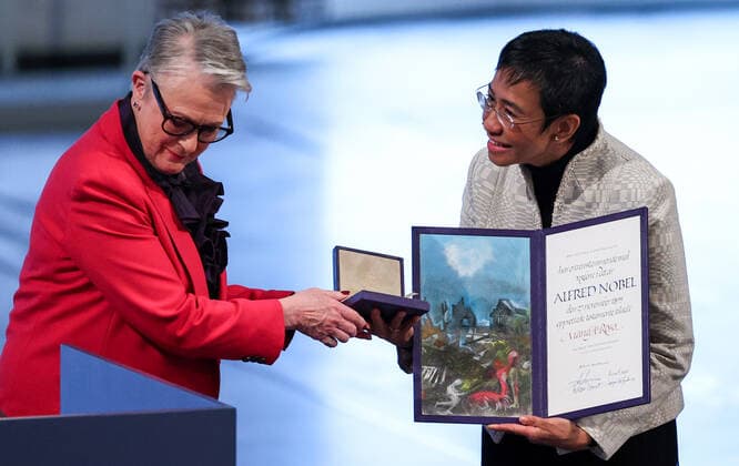 OSLO, NORWAY â€“ DECEMBER 10, 2021: Norwegian Nobel Committee Chairwoman Berit Reiss-Andersen (L) presents the 2021 Nobel Peace Prize to Filipino-American journalist, co-founder and CEO of Rappler Maria Ressa in recognition of her efforts to safeguard freedom of expression, which is a precondition for democracy and lasting peace , at a ceremony at Oslo City Hall. Sergei Bobylev TASS  TS11B5E1